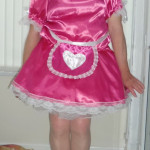 sissy-charlotte-pink-maid-with-her-knees-tight-together