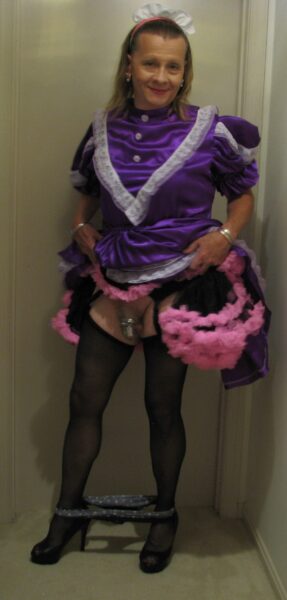 chrisissy-sissy-doll-in-purple-sissy-dress-and-pink-petticoat-locked-in-her-chastity-cage